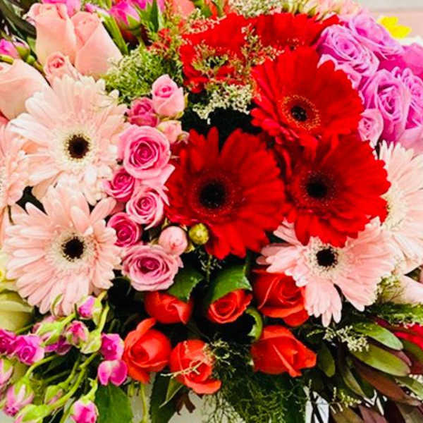 Mixed bouquet of pink, red, and white flowers