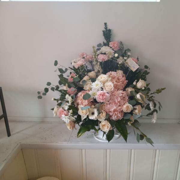 Pink and white floral arrangement in a white vase