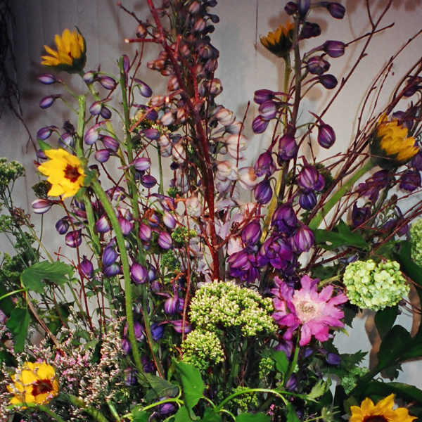 Tall mixed bouquet with yellow sunflowers and purple blooms