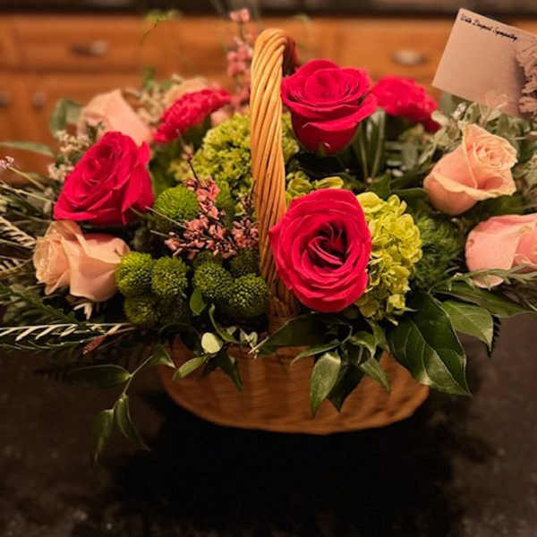 Basket arrangement with red and blush roses