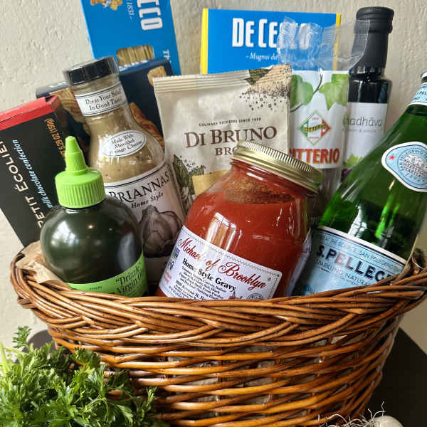Gift basket with pasta, sauce, cheese, olive oil, and sparkling water