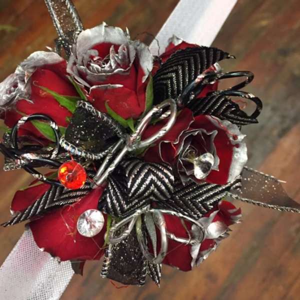 Small bouquet of red roses with black and silver ribbon accents