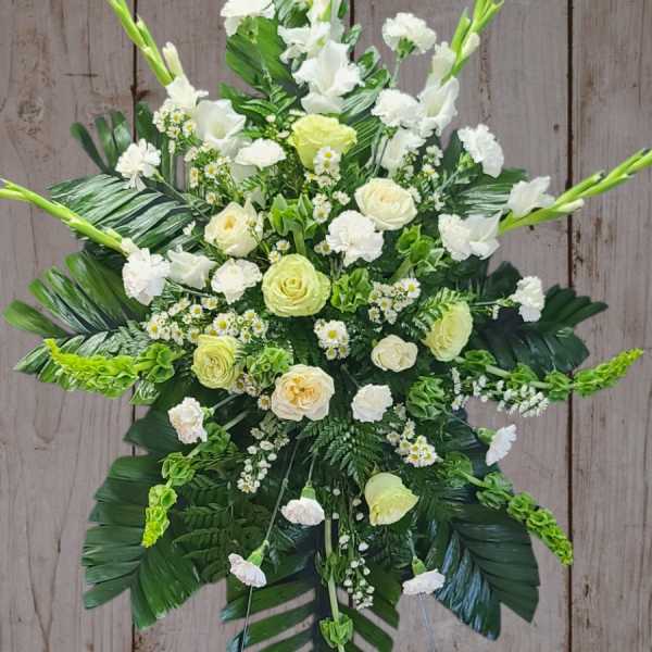 White and pale green floral standing spray on an easel
