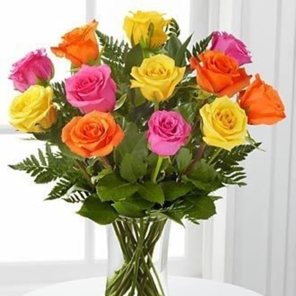 Bouquet of multicolored roses in a clear glass vase