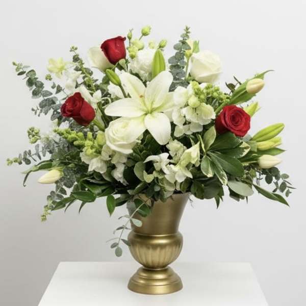 White lilies and red roses in a gold vase