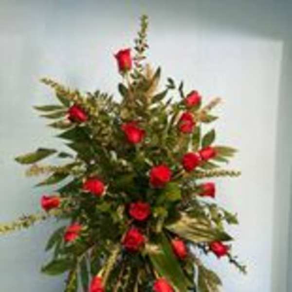 Tall standing arrangement of red roses and greenery