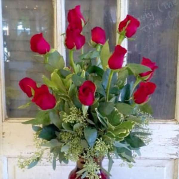 Red roses arranged in a red vase