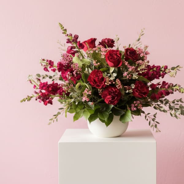 Red rose bouquet in a white bowl vase