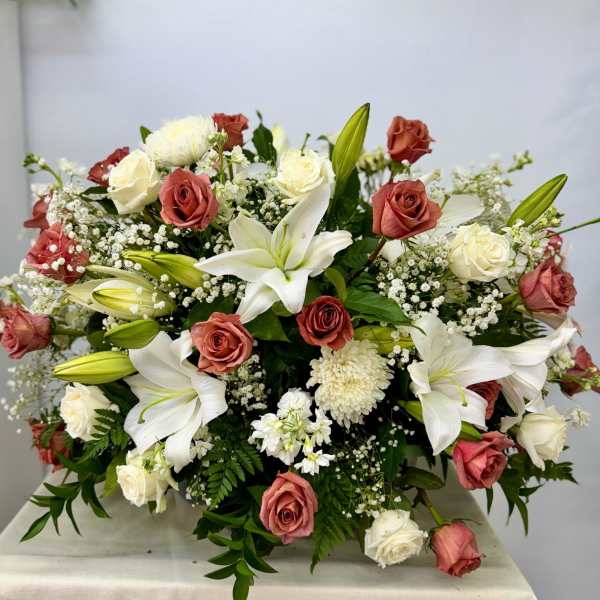 Large bouquet of white lilies and pink roses with baby's breath