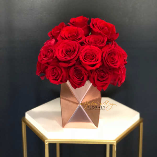 Red rose bouquet in a geometric metallic vase