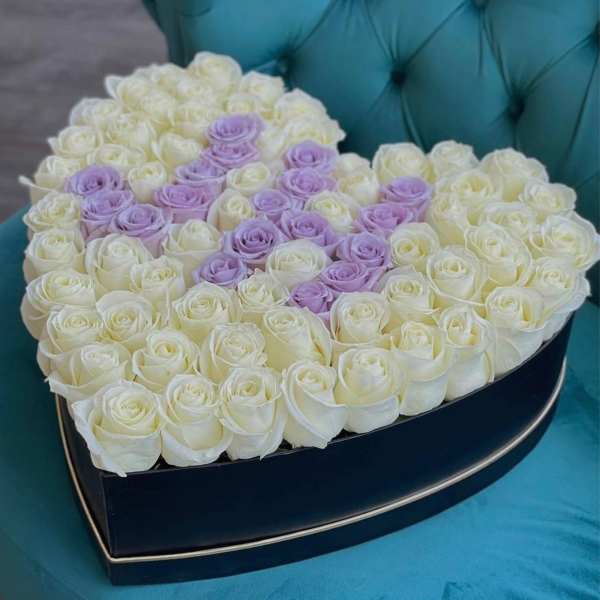 Heart-shaped box filled with white and lavender roses