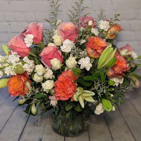 Pink and orange mixed bouquet in a glass vase