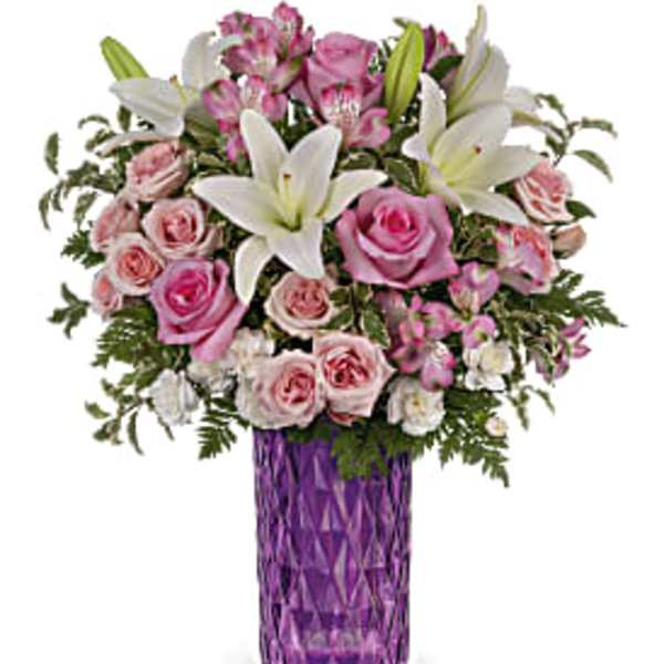 Pink and white flower bouquet in a purple vase