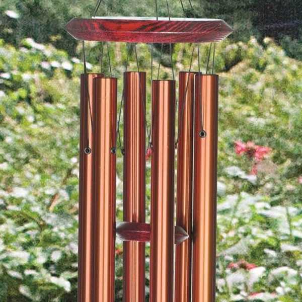 Copper wind chime hanging outdoors in a garden