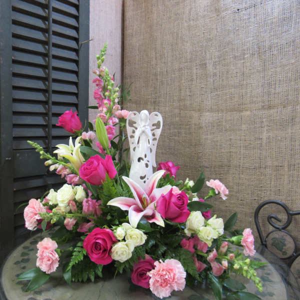 Pink and white floral arrangement with roses, lilies, and carnations