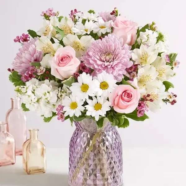 Pink and white mixed bouquet in a textured glass vase