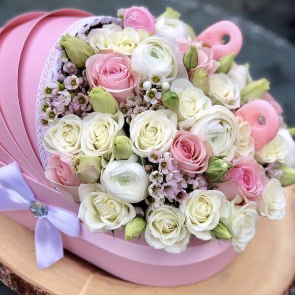 Pink and white rose bouquet in a pink hat box with a lavender ribbon