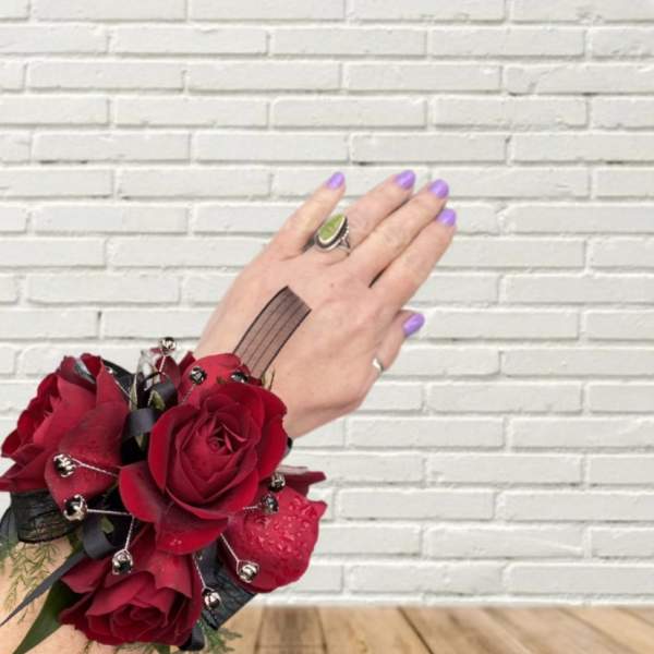 Red rose wrist corsage with black ribbon and silver accents