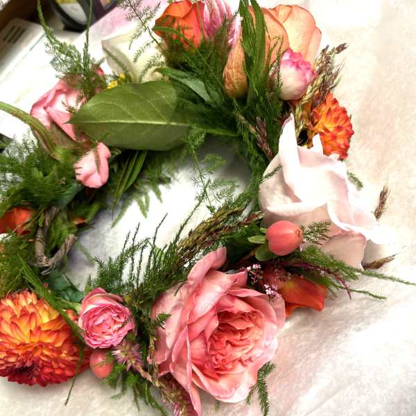 Pink and orange floral wreath with roses and dahlias