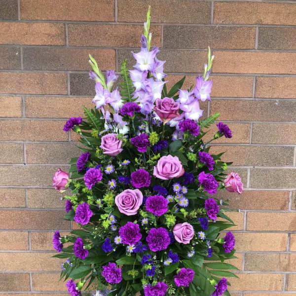 Standing floral spray with purple roses and lilies