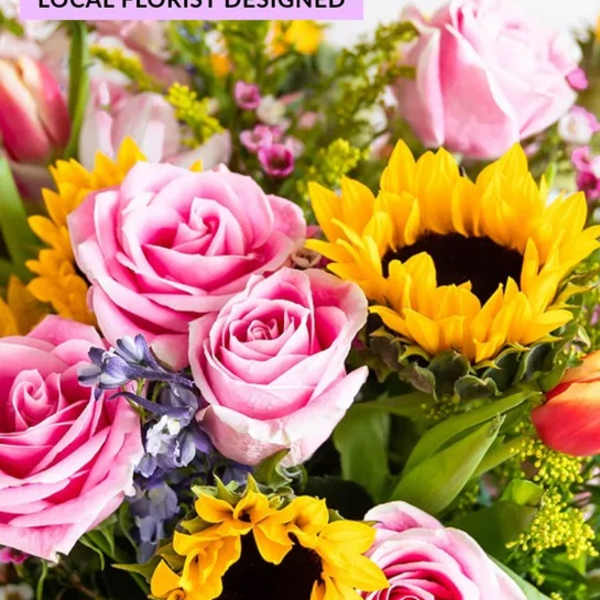 Bouquet of pink roses and yellow sunflowers with mixed blooms