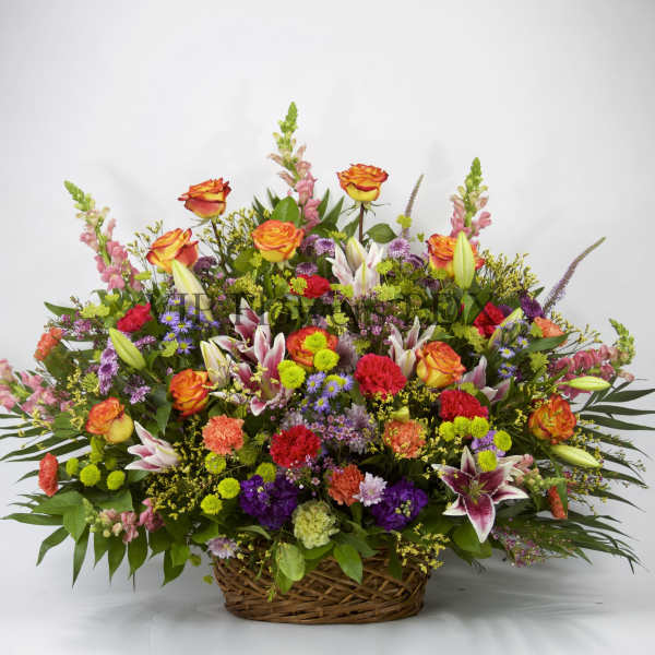 Large mixed flower basket with orange roses and lilies