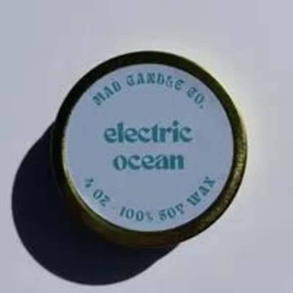 Round tin labeled electric ocean with a dark lid