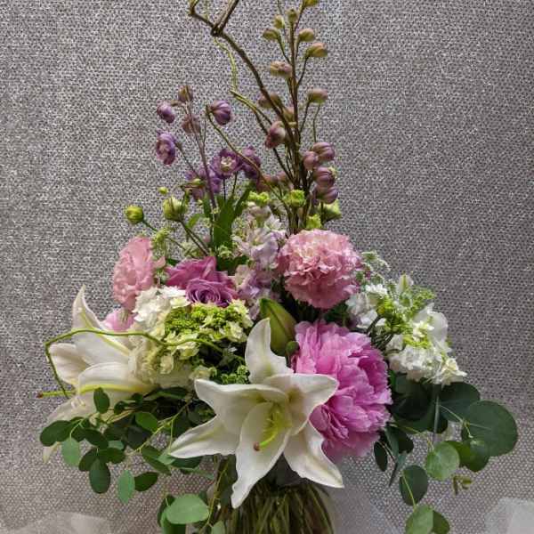 Pink and white floral arrangement in a glass vase