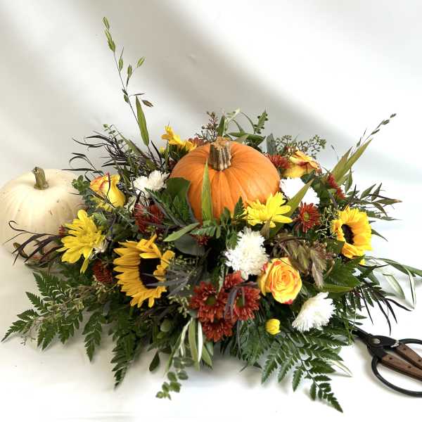 Autumn floral arrangement with pumpkins and sunflowers