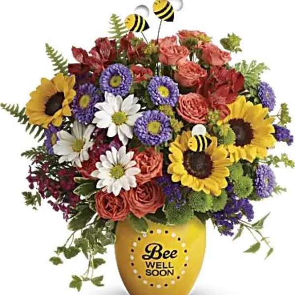 Mixed bouquet in a yellow vase with bee decorations