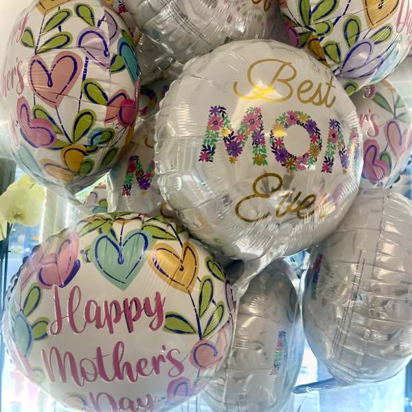 Cluster of Mother's Day balloons with colorful heart patterns and floral text