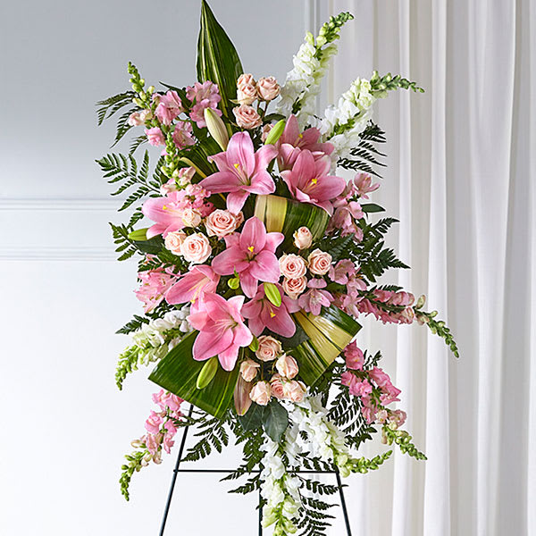 Standing floral spray with pink lilies, roses, and white snapdragons
