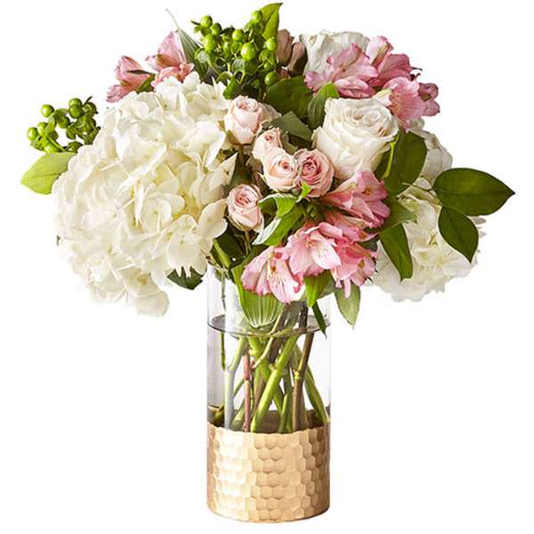 Bouquet of white and pink flowers in a clear glass vase