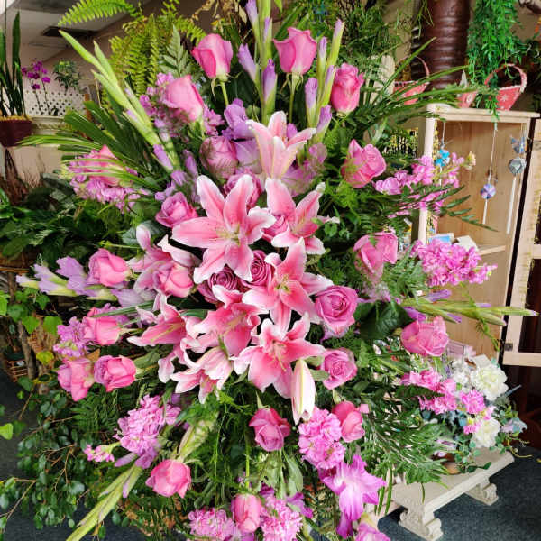 Large pink floral standing spray with lilies and roses