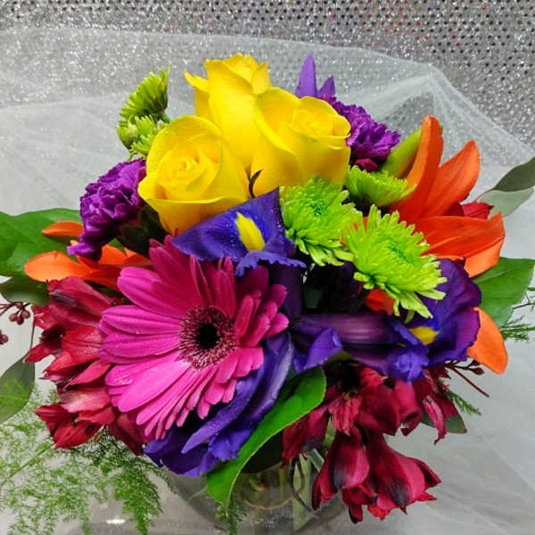 Colorful bouquet with yellow roses, gerbera daisies, and purple flowers