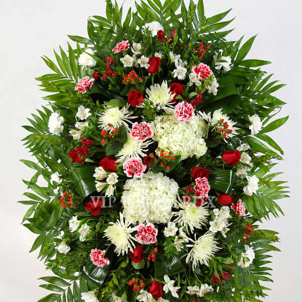 Large standing floral spray with red, white, and pink flowers