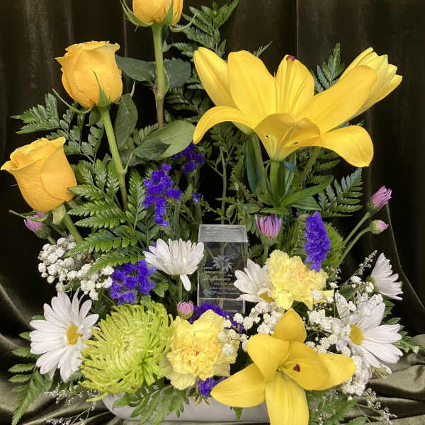 Yellow roses and lilies with white daisies in a low arrangement