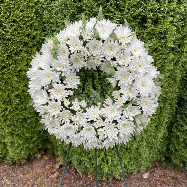 White chrysanthemum wreath on a standing easel
