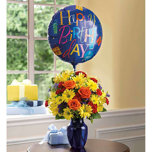 Birthday bouquet in a blue vase with a birthday balloon