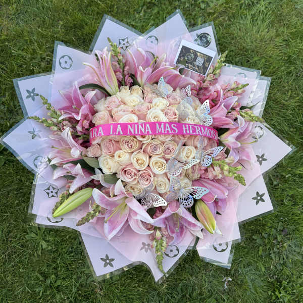 Pink and cream rose bouquet with lilies and butterfly accents