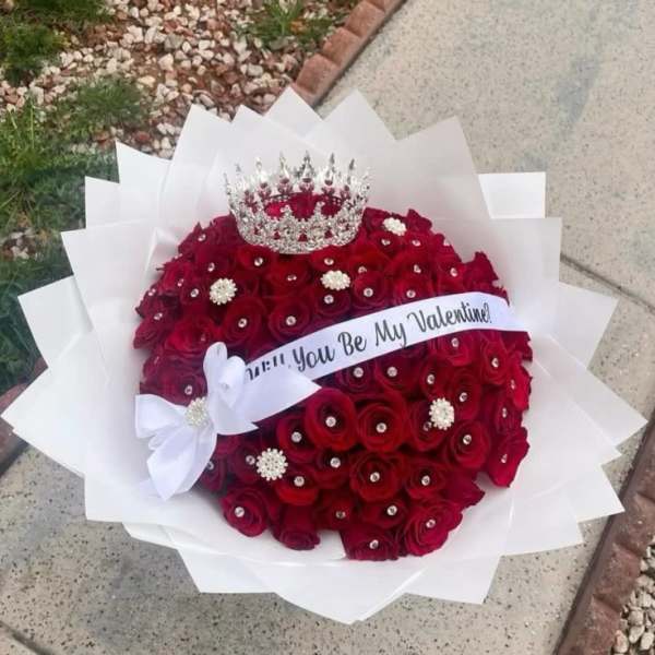 Red rose bouquet with a crown and Valentine ribbon