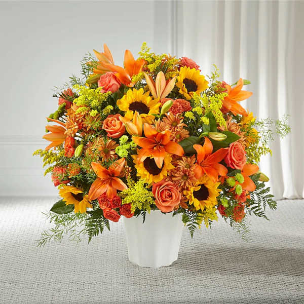 Orange and yellow mixed bouquet in a white vase