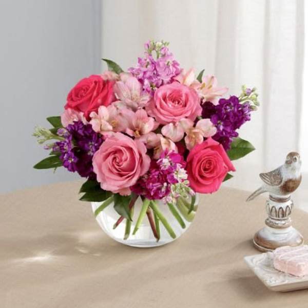 Pink and purple mixed bouquet in a clear glass vase