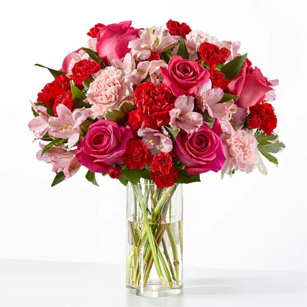 Pink and red mixed bouquet in a clear glass vase
