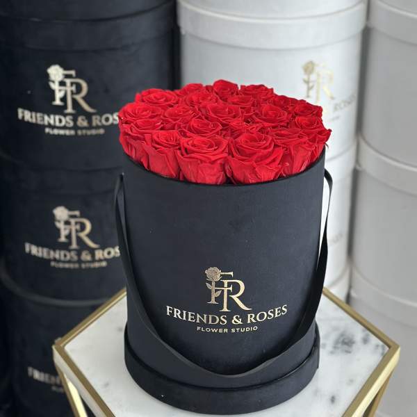 Round box of red roses with black ribbon