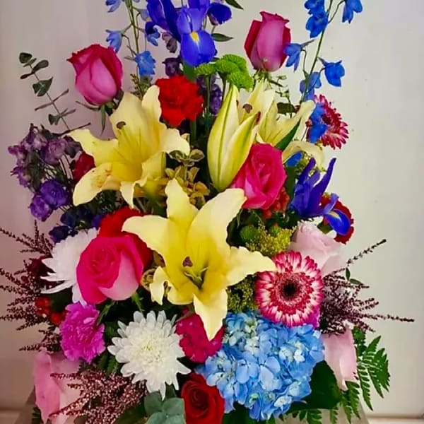 Colorful mixed bouquet with roses, lilies, hydrangea, and daisies