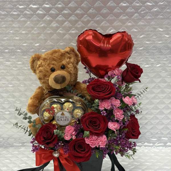 Teddy bear with roses, heart balloon, and chocolates in a black box