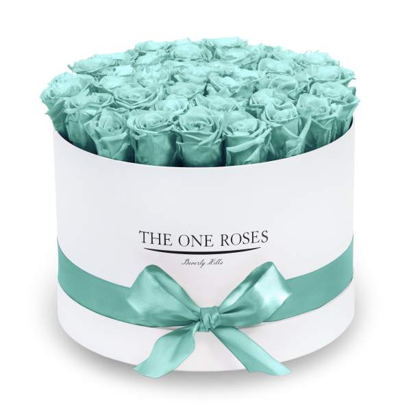 Round box of turquoise roses with a satin ribbon