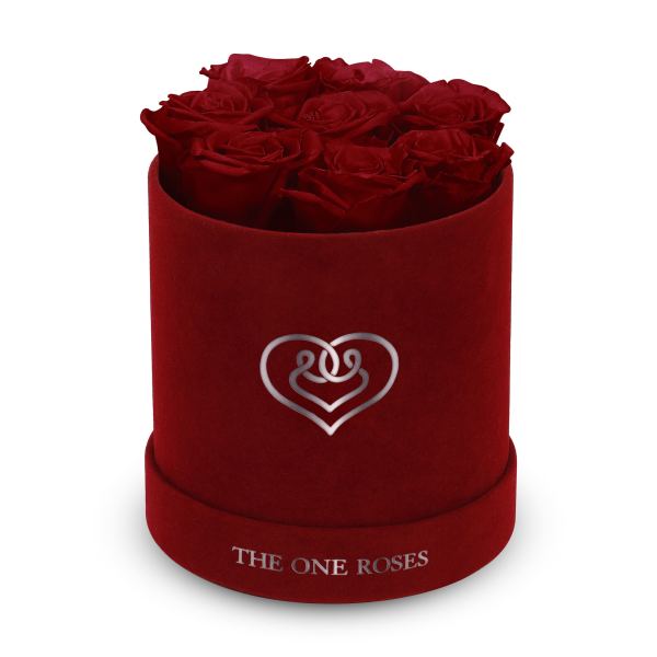 Red roses arranged in a velvet round box with a heart emblem