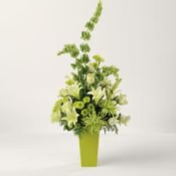 Tall green and white flower arrangement in a lime green vase